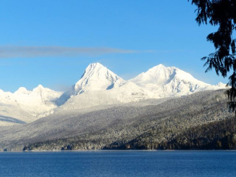 The Snow Capped Mountains Surrounding Lake Mcdonald